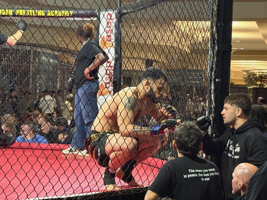 Marcus Arens talks with his corner before the fight.