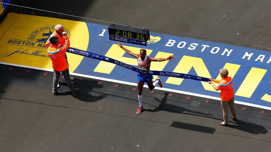 American Meb Keflezighi crosses the finish line in first place to win the 2014 B.A.A. Boston Marathon on Monday. He became the first American man to win the Boston Marathon since 1983.