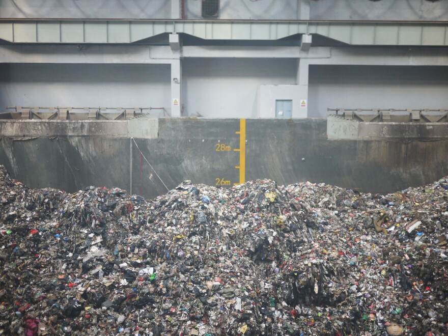 Inside Beijing's Gao'antun incinerator plant, garbage piles past the 25-meter (82-ft.) mark inside an arena-sized garbage container where engineers operate giant claws to sift through it.