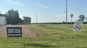 Two signs with opposing stances on the possibility of a data center being created are shown on land in Salix, Iowa, on July 8, 2026. (Bret Hayworth, Siouxland Public Media News)