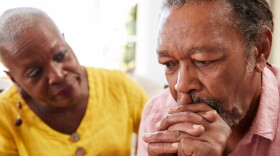 Senior Woman Comforting Man With Depression At Home