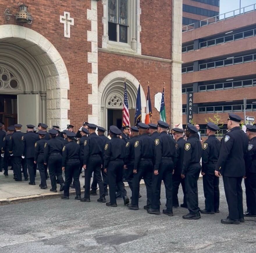 Police officers enter St. Mary's Roman Catholic Church in Albany on Tuesday, May 5, 2026, for a memorial Mass for officers who have died in the line of duty across New York state.