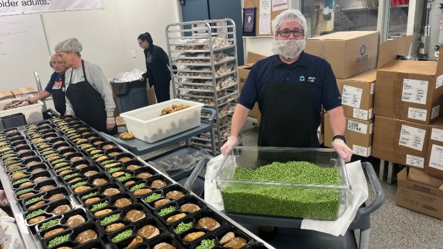 Ruch preparing meal trays for delivery to seniors in West Michigan