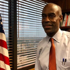Broward Schools Superintendent Robert Runcie stands in an office next to a Florida state flag