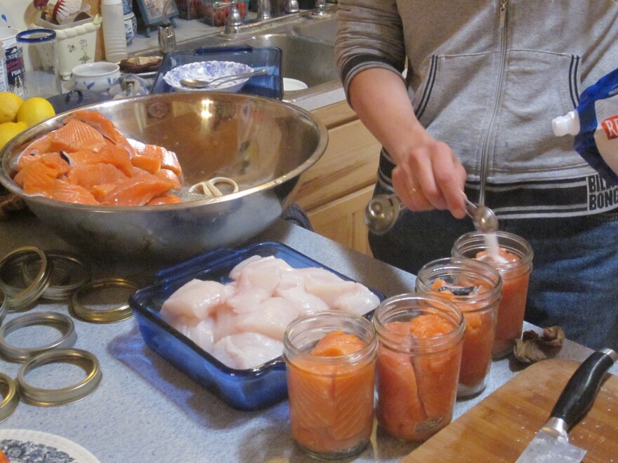 Jenny Wise, of South Thorne Bay, preps cuts of Coho salmon and Pacific halibut for canning.