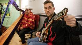 Latingrass singer-songwriters and instrumentalists Larry Bellorín (left) and Joe Troop (right) tune up at the Here & Now studios in Boston. (Robin Lubbock/WBUR)