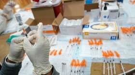 A Northwell Health registered nurse fills a syringe with a COVID-19 vaccine at a pop up vaccination site the Albanian Islamic Cultural Center, April 8, 2021, in the Staten Island borough of New York. (AP Photo/Mary Altaffer, file)