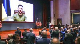 Members of Congress give Ukraine President Volodymyr Zelensky a standing ovation before he speaks in a virtual address to Congress in the U.S. Capitol Visitors Center Congressional Auditorium in Washington, Wednesday, March 16, 2022. (Sarahbeth Maney/The New York Times via AP, Pool)