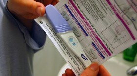 A pregnancy test, faintly positive, which the couple later discovered was expired by six months.