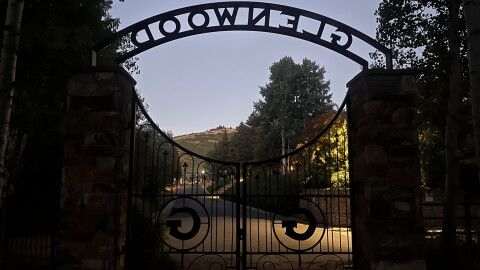 The Glenwood Cemetery gate is seen at dusk Aug. 18, 2025.