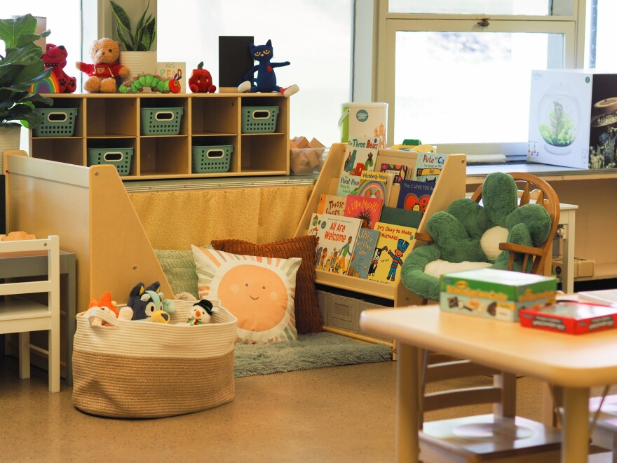A preschool classroom, with plush toys and boys and small furniture