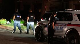 York Regional Police work the scene of a gun and drug bust that saw authorities arrest 22 people on more than 400 charges.