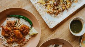 A closeup of Pakistani curry and rice dishes.