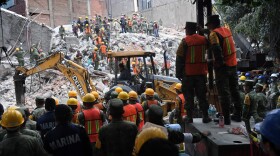 Volunteers remove rubble during the search for survivors in a flattened building in Mexico City on Sept. 20, 2017, after a strong quake hit central Mexico. (Pedro Pardo/AFP/Getty Images)