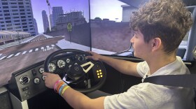 Tamarac High School student Mike Plante pilots a truck simulator 