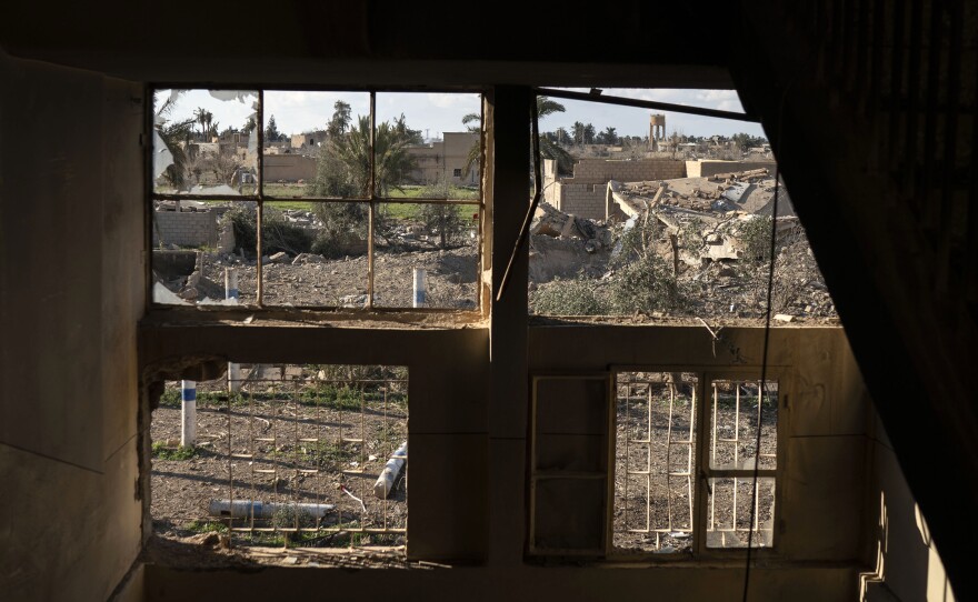 Destroyed homes are framed by damaged windows in a building taken by Syrian Democratic Forces in Baghouz, on Feb. 18.