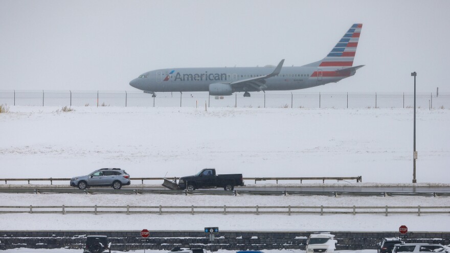A jet waits for takeoff Tuesday at Denver International Airport, where travelers have seen hundreds of flights canceled amid heavy snow.