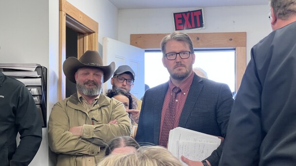 Cass County Attorney Ben Lindstrom, right, stands next to Deputy Aaron Ammerman after presenting a request for board action to Cass County Board to require Ammerman take a leave of absence while he runs for sheriff. The meeting was May 19, 2026, at May Town Hall in rural Motley.