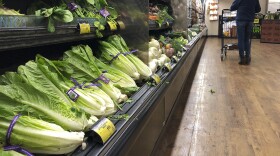 Romaine Lettuce still sits on the shelves as a shopper walks through the produce area of an Albertsons market Tuesday, Nov. 20, 2018, in Simi Valley, Calif. Health officials in the U.S. and Canada told people Tuesday to stop eating romaine lettuce because of a new E. coli outbreak.