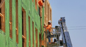 Workers are pictured at the construction site of a new apartment building in Lakewood, Ohio, Tuesday, July 15, 2025.