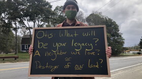 Jeremy Shea protests against the Mass. Army National Guard's proposed machine gun range outside the Forestdale School in Sandwich on Oct. 12, 2020.