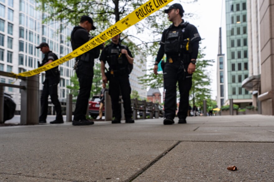 U.S. Secret Service Police officers place crime scene tape after a copper jacket of a bullet was found near the scene of a shooting close to the White House, Sunday, May 24, 2026, in Washington. (AP Photo/Alex Brandon)