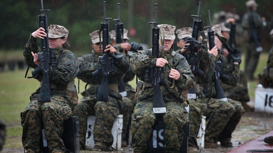 Female Marine recruits train on the rifle range during boot camp at Parris Island, S.C., on Feb. 25. The Marine Corps said it has postponed new physical standards that would require women to do three pullups, noting that many female recruits were not yet able to do so.