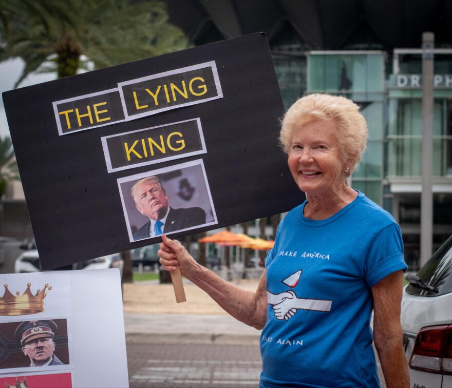 Jane Berg holds a sign and encourages passing drivers to honk during the No Kings: Vote Early rally. Berg said she participated in the women’s movement in the early 1970s, which helped mobilize voters and push for policy reforms.