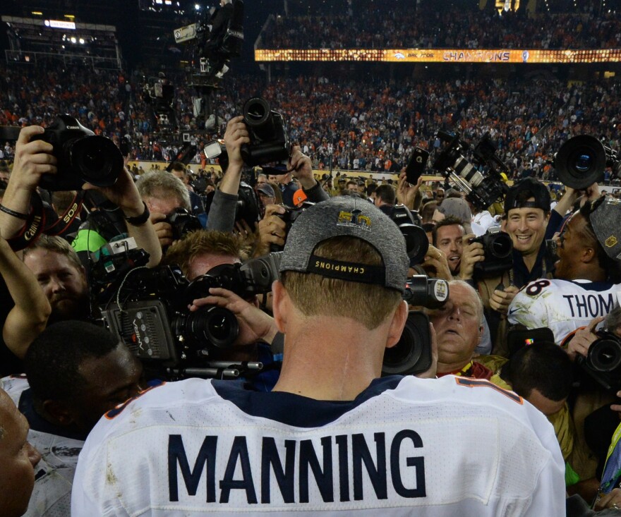 Peyton Manning wades through a swarm of media after the Broncos defeated the Panthers. It is his second Super Bowl victory.