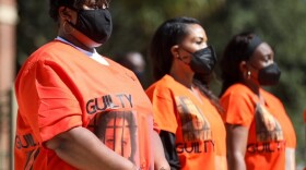 Outside of the Glynn County Courthouse, Ahmaud Arbery's aunt, Thea Brooks, joins a group during a demonstration calling for the conviction of the three men who face charges in the death of Ahmaud Arbery and other county officials they say were complicit in his death.