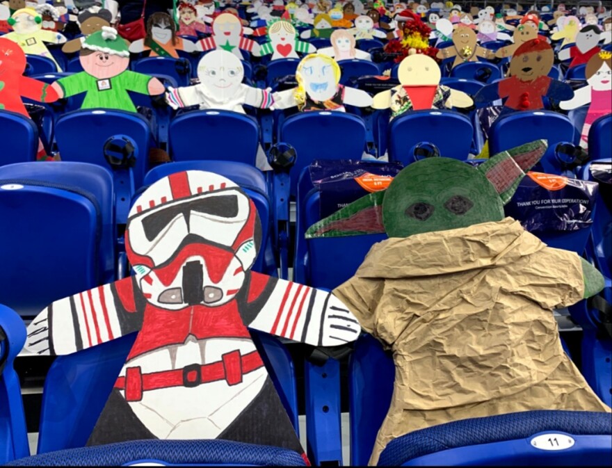 Cardboard fans take up the end zone near the goal for Colorado in the Alamodome.