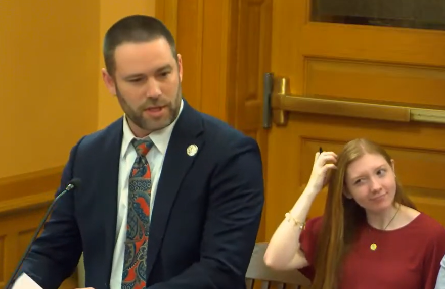 Republican Rep. Sean Willcott briefs fellow lawmakers in a February hearing on how AI chatbots work and what they can responsibly be used for.