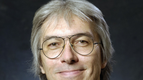 T. Crunk with gray hair wearing glasses and a black shirt