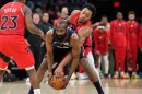 Cleveland Cavaliers guard James Harden, center, keeps the ball fron Toronto Raptors forward Scottie Barnes, right, in the second half in Game 2 of a first-round NBA basketball playoffs series in Cleveland, Monday, April 20, 2026. 