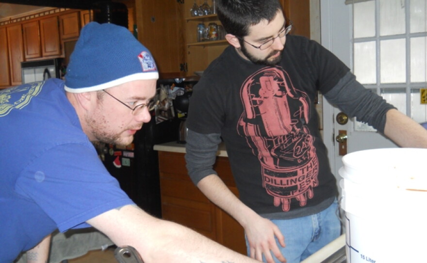 Homebrewers Owen McLaughlan and Jon Peck check the water level of a soon-to-be stout.