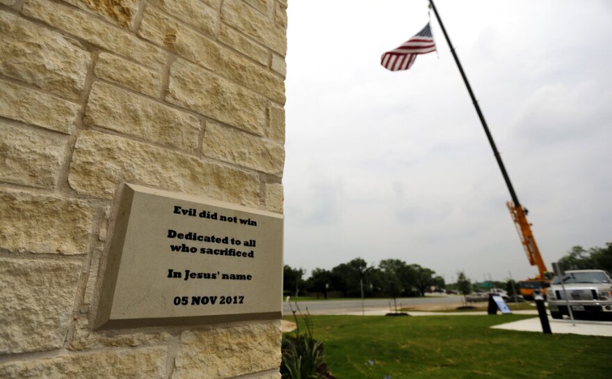 A buff colored plaque on the stone exterior of the new sanctuary for First Baptist Church Sutherland Springs reads "Evil did not win / Dedicated to all who sacrificed / In Jesus' name / 05 Nov 2017"