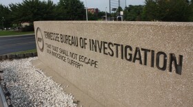 The wife of the agency's interim director says he used state resources to conduct an affair.