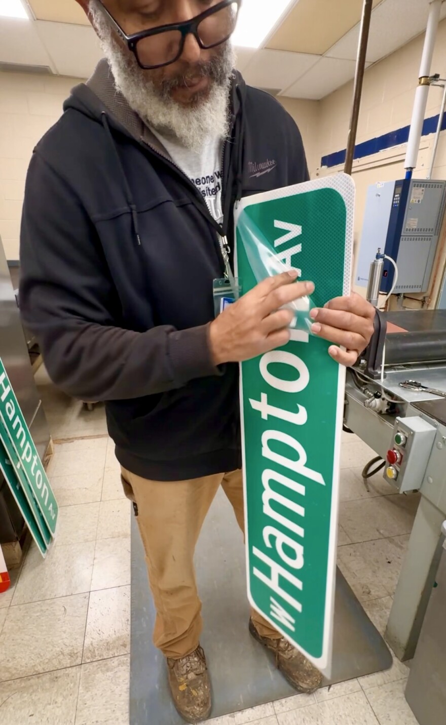 Larry Jackson and his fresh pressed Hampton Ave sign