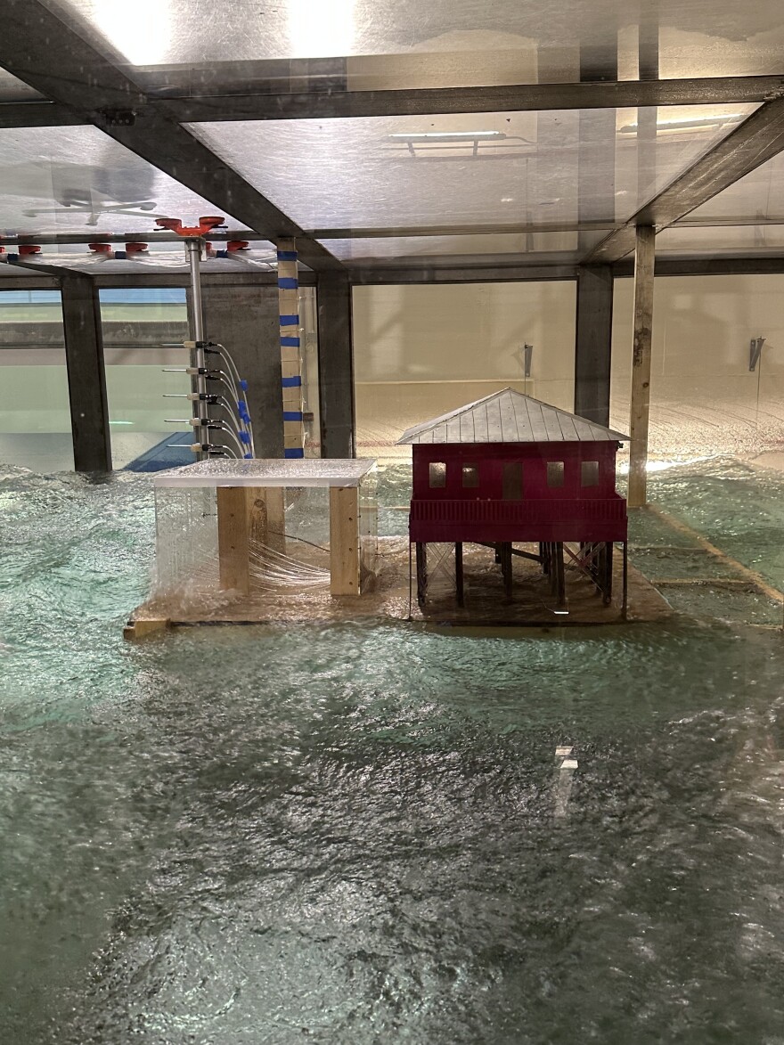 Two model-sized structures are subjected to hurricane-force winds and waves at a 38,000-gallon tank at the University of Miami Rosenstiel School.