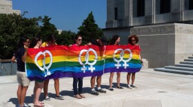 FILE: A group from Baton Rouge's L Bar holds up a pride banner at the capitol, June 23, 2012. 