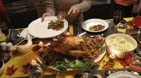 A woman serves stuffing from a Thanksgiving turkey. (John Moore/Getty Images)
