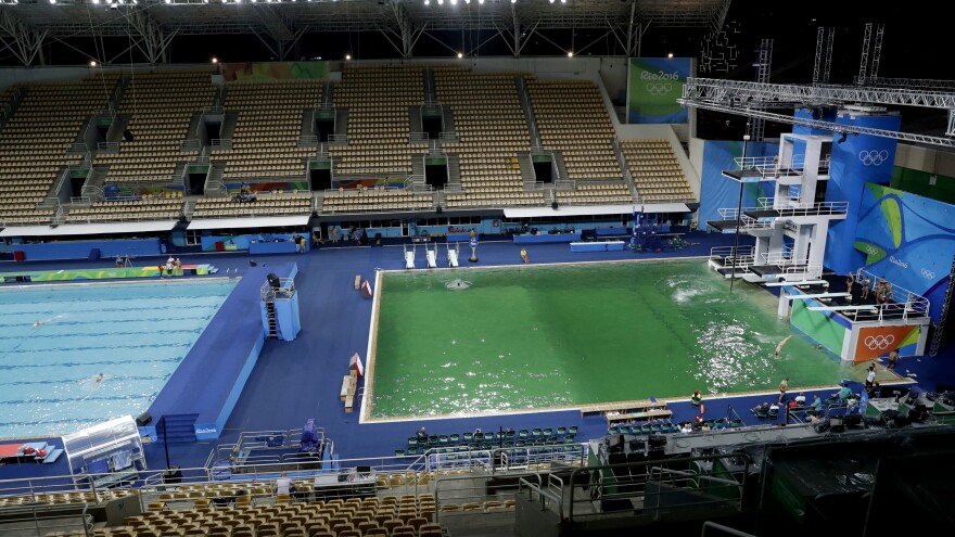 The water in the diving pool at right is a murky green, in stark contrast to the clear blue water in the water polo pool at the Maria Lenk Aquatic Center on Tuesday. Officials say the green tint was the result of algae, which grew because of a lack of disinfectant.