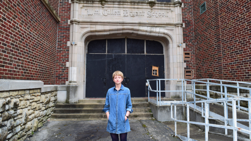 Carter Taylor stands at the boarded-up entrance of the Bryant School, which KCPS hopes to convert into affordable workforce housing.