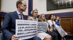 Michael Stumo and his wife Nadia Milleron, who lost their 24-year-old daughter in the March 2019 Ethiopian Airlines crash, hold up signs depicting those lost in the crash and on Lion Air Flight 610 during a congressional hearing in Washington, D.C. (Andrew Harnik/AP)