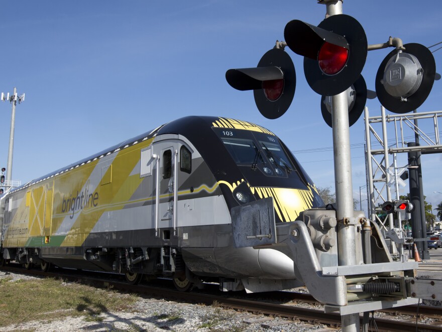 A Brightline train approaches a railroad crossing on Jan. 18, 2018, in Fort Lauderdale, Fla. In its first two years, more than 40 people have been killed by Brightline trains on tracks and at rail crossings.