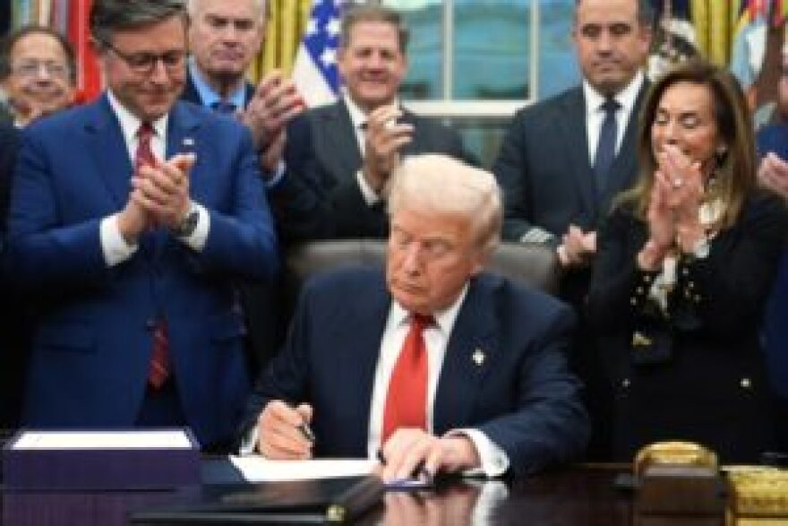 President Donald Trump signs the funding bill to reopen the government, in the Oval Office of the White House, Wednesday, Nov. 12, 2025, in Washington.