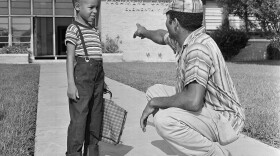 James E. Smith and his son James Jr., 6, stand in front of Kashmere Gardens Elementary School in Houston on Sept. 7, 1960. The Texas Tribune explored the legacy of desegregation and its continuing impact in a series of stories called "Dis-Integration."