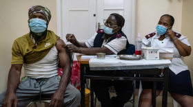 A man is vaccinated against COVID-19 at a clinic in Johannesburg, South Africa. The omicron variant appears to be driving a surge in South Africa. New studies suggest that vaccines might not be as effective against this variant but that a booster shot can be helpful.Shiraaz Mohamed/AP