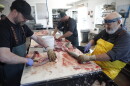 Jim VerSnyder (right) filets a whitefish at Carlson's Fishery in April, 2024. (credit: Dan Wanschura / Points North)
