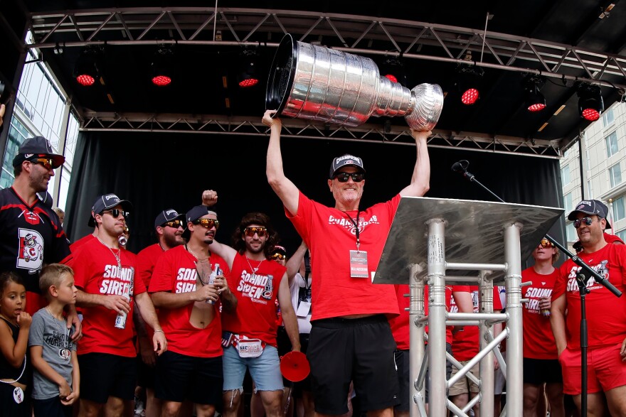 Carolina Hurricanes majority owner Tom Dundon holds the Stanley Cup in the air during the NHL hockey club's championship celebration in Raleigh, N.C., Saturday, June 20, 2026.